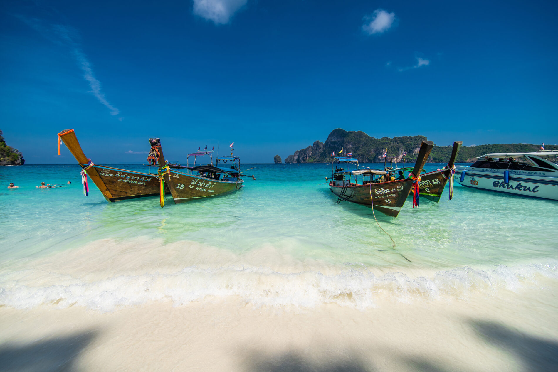 Long Tail Boats parking at the white and beach on Phi phi island in Thailand