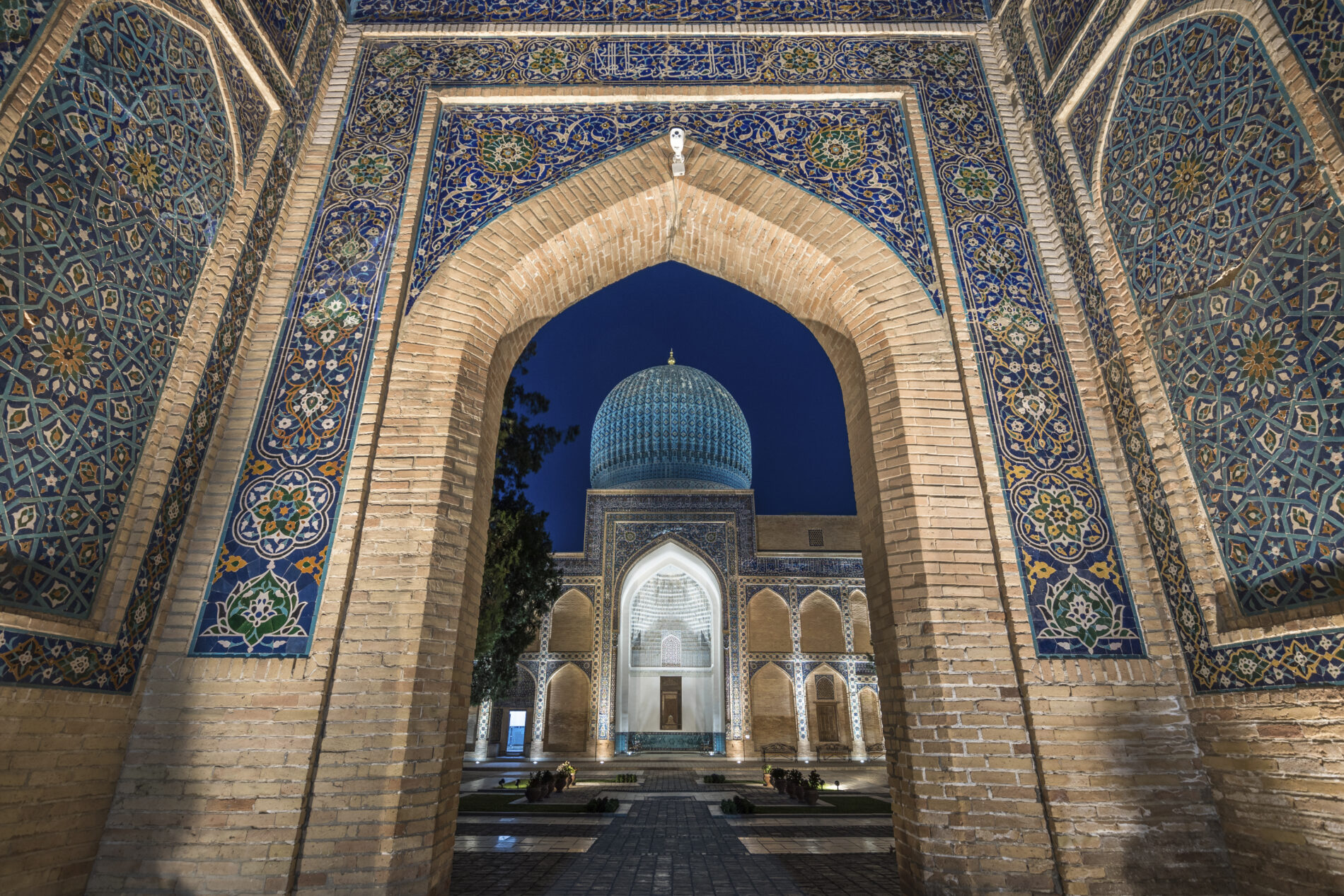 Archway inlaid with vibrant mosaic tile patterns, The Registan, a historic 15th century Madrasa building.,Samarkand