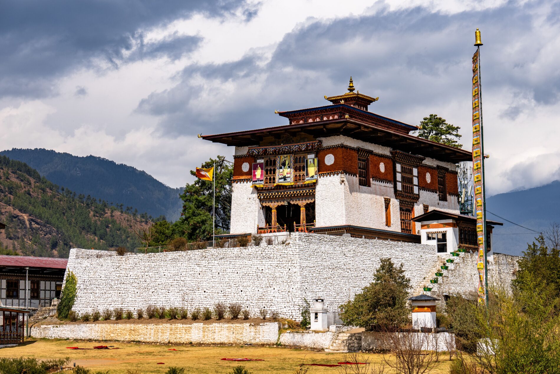 Traditional Bhutanese temple with mountainous backdrop.
